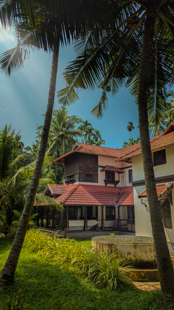 Experience a luxurious stay surrounded by lush greenery and traditional architecture in Kerala, India.